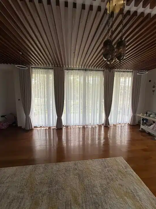 Layered windows beneath a timber slatted ceiling