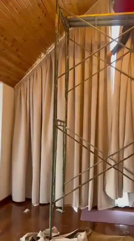 A closer look at the tall pitched-roof curtain installation while fitting is underway.